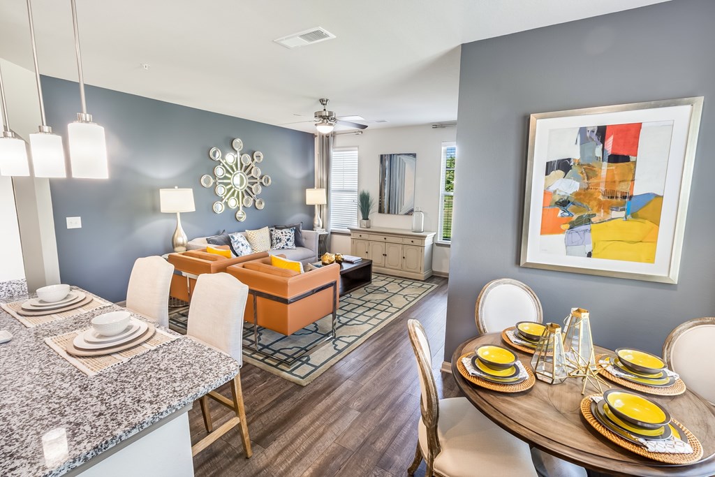 A modern dining room with a round table set for six.