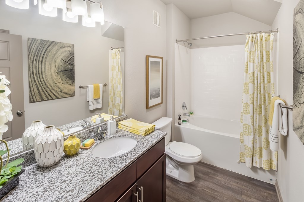 A bathroom with a white sink and a white toilet.