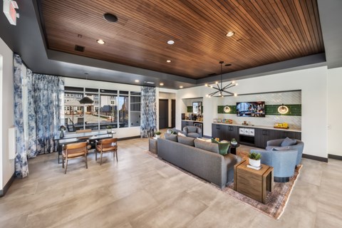 A modern living room with a grey sofa and wooden coffee table.