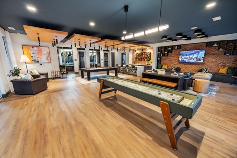 A room with a pool table and a bar.
