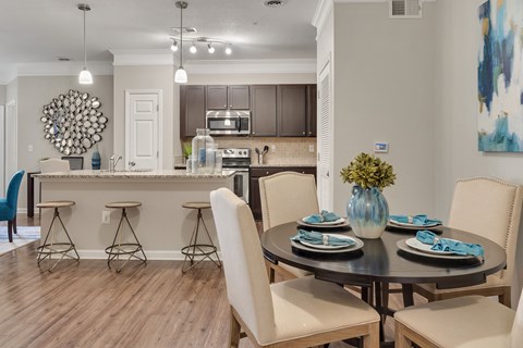 A modern dining room with a round table set for four at Echo at Lake Norman, Mooresville