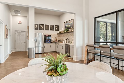 A white table with a plant on it in a kitchen.