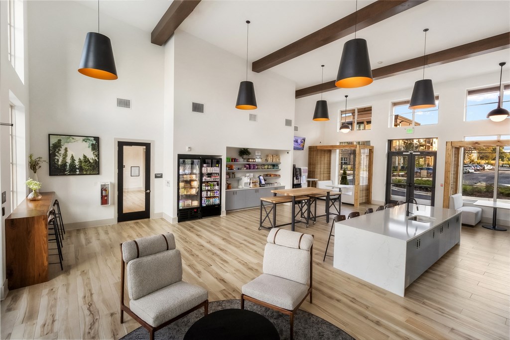 a communal area with a kitchen and a table with chairs