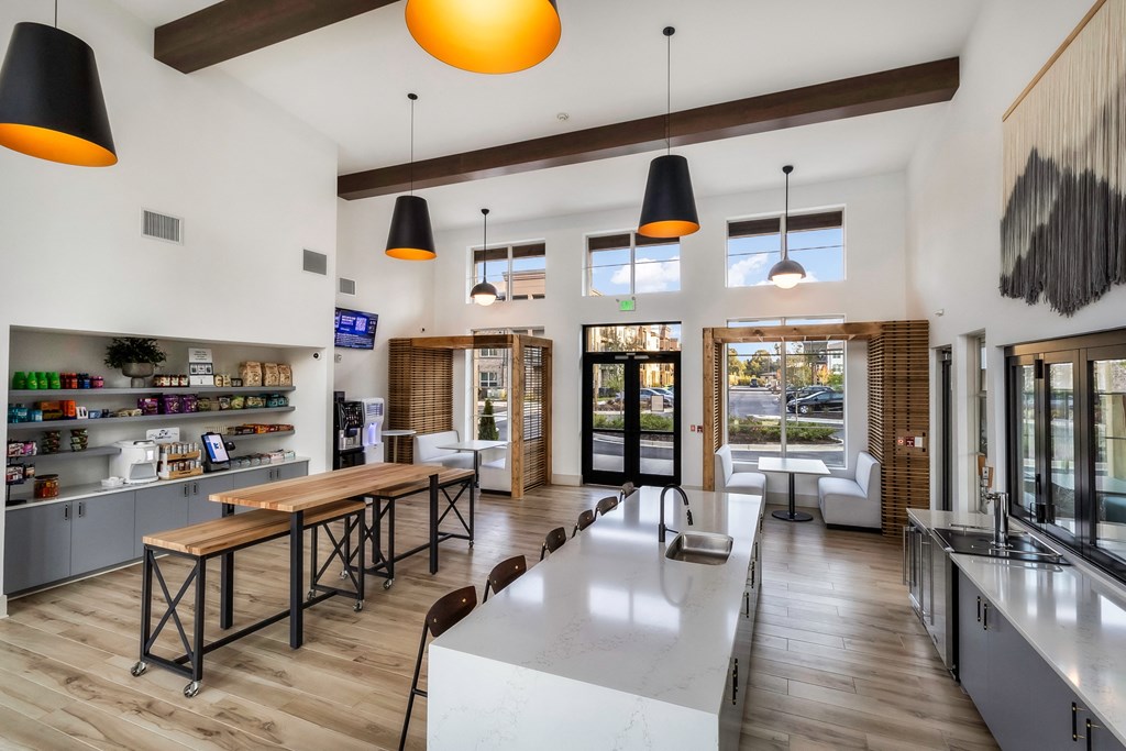 a kitchen and dining area with a wooden table and counter tops