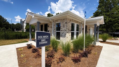 A small building with a sign that says Dog Wash Bike Storage.
