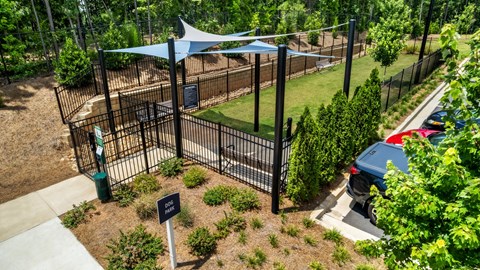 A black metal fence with a blue canopy and a sign on it.