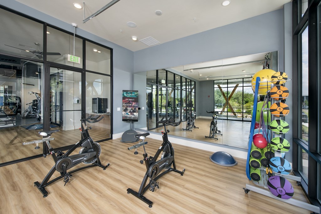 a gym with cardio equipment and weights