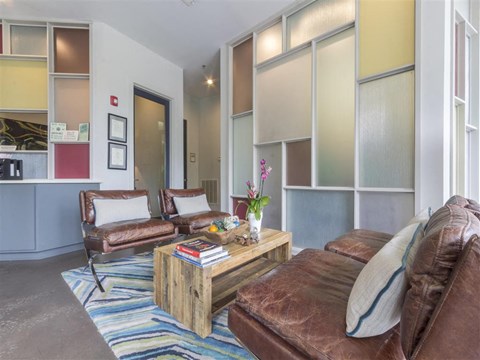 A living room with brown leather couches and a wooden coffee table.