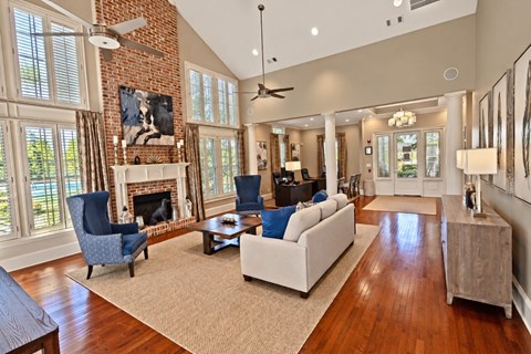 A living room with a fireplace and a blue chair.