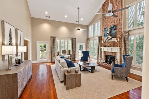 A living room with a fireplace and a painting on the wall.