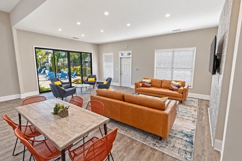 A living room with a dining table and chairs.