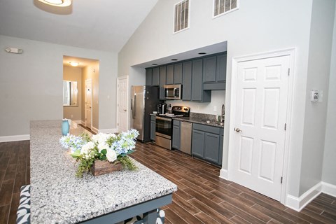 an open kitchen and living room with a counter top