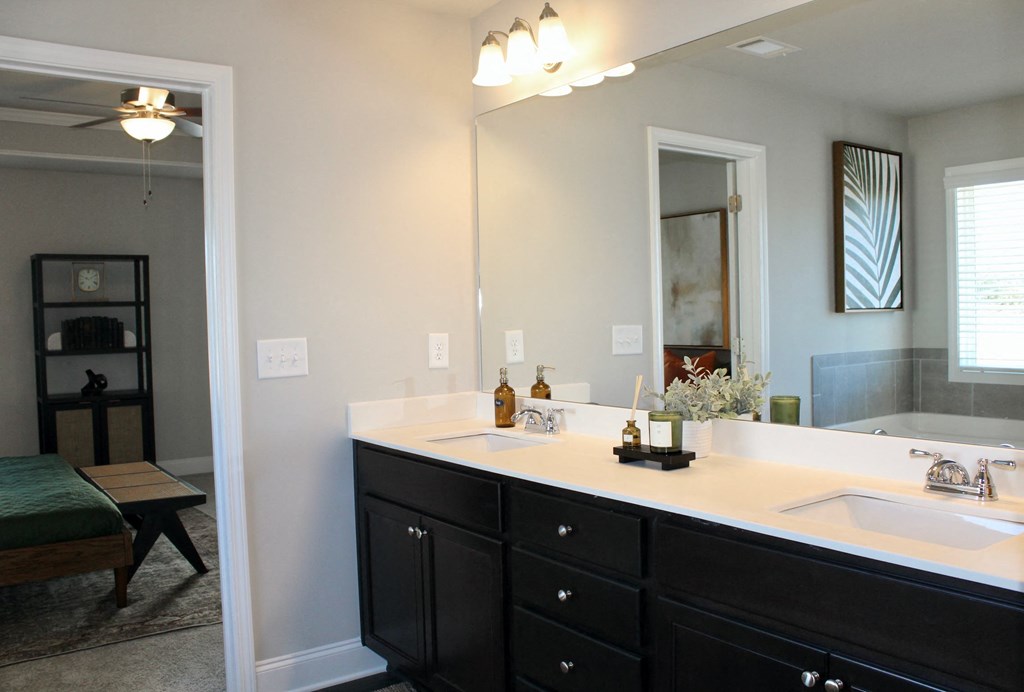 a bathroom with two sinks and a large mirror