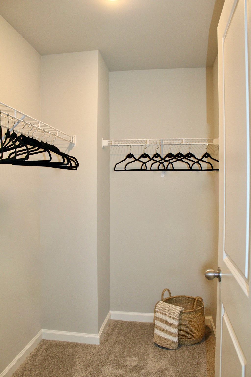 a closet with shelves and a basket on the floor