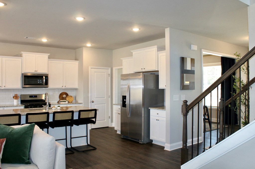a kitchen with stainless steel appliances and white cabinetry