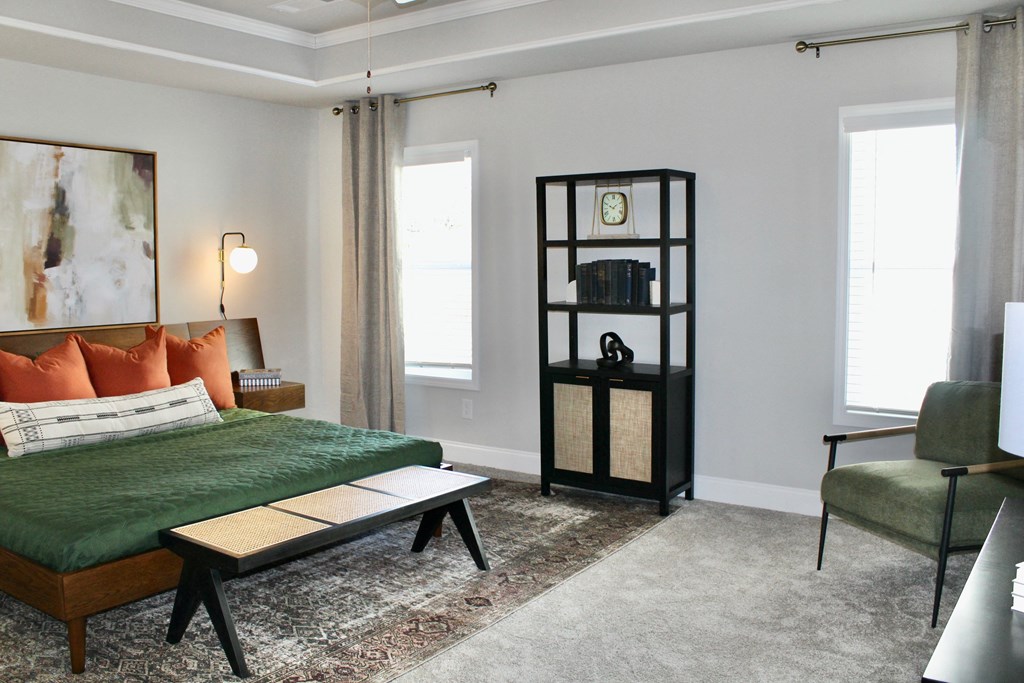 a bedroom with a bed and a bookcase in the corner