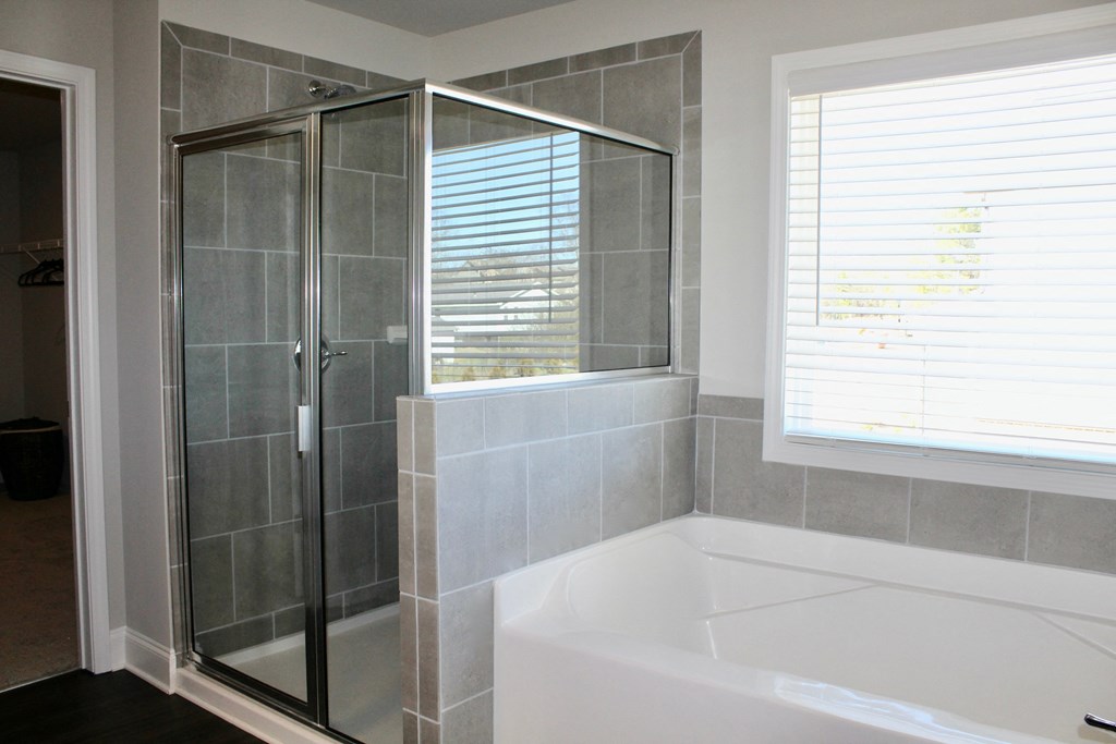 a small bathroom with a tub and a shower