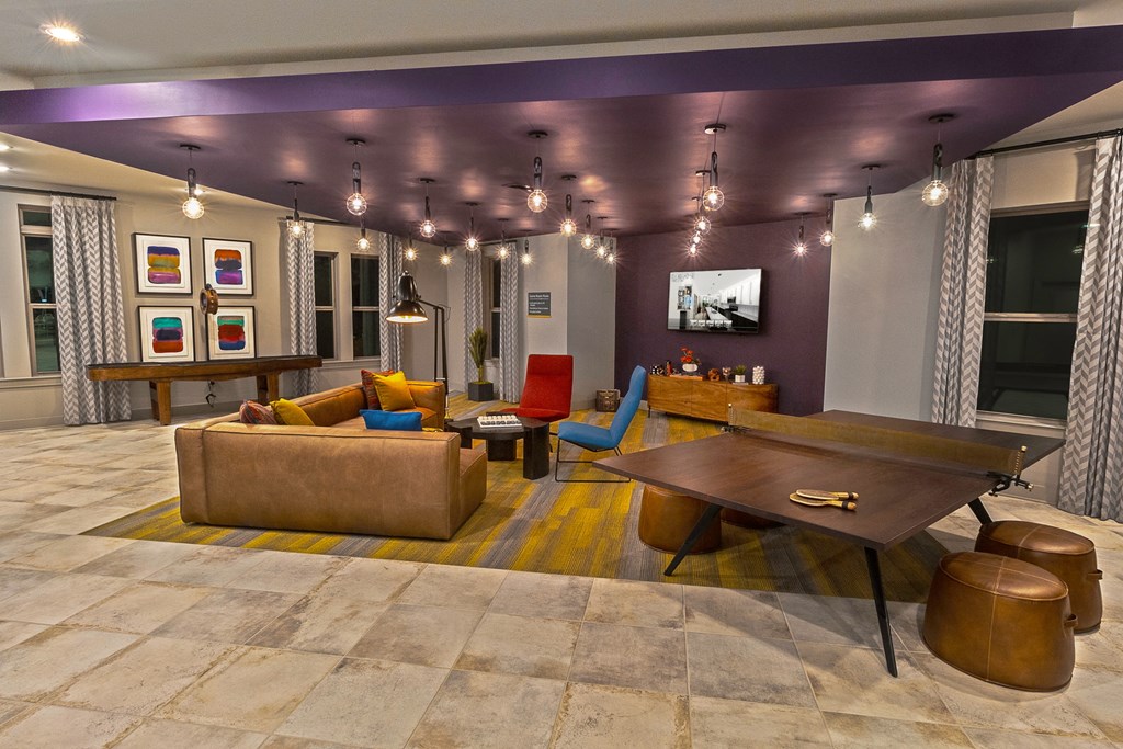 a living room with couches and chairs and a table