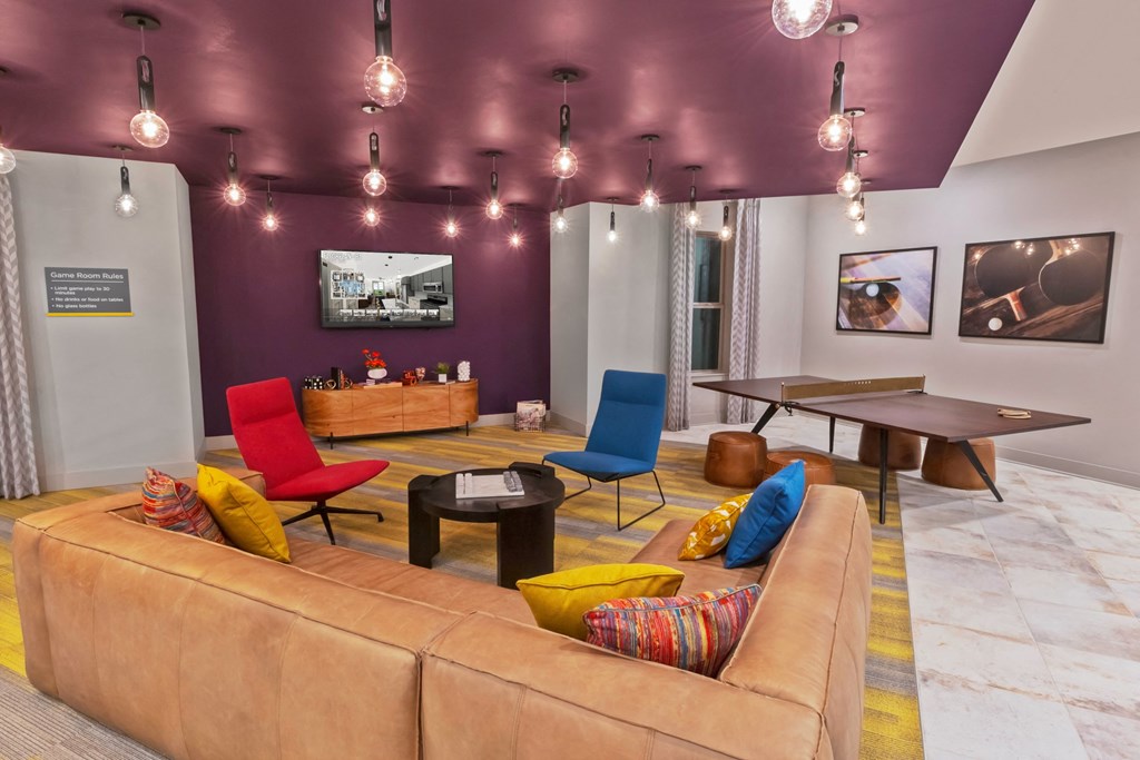 a living room with a couch and chairs and a table