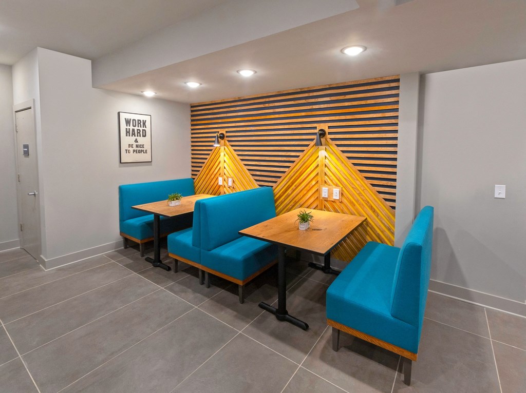 a dining room with blue chairs and wooden tables