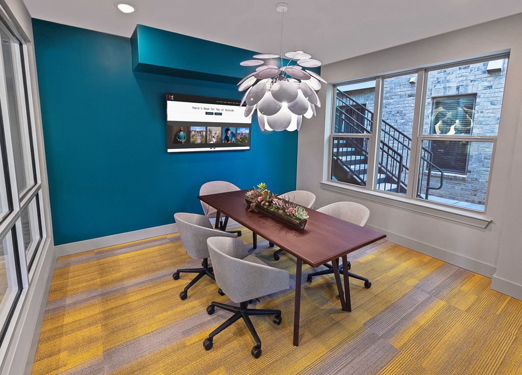 a dining room with a table and chairs and a ceiling fan