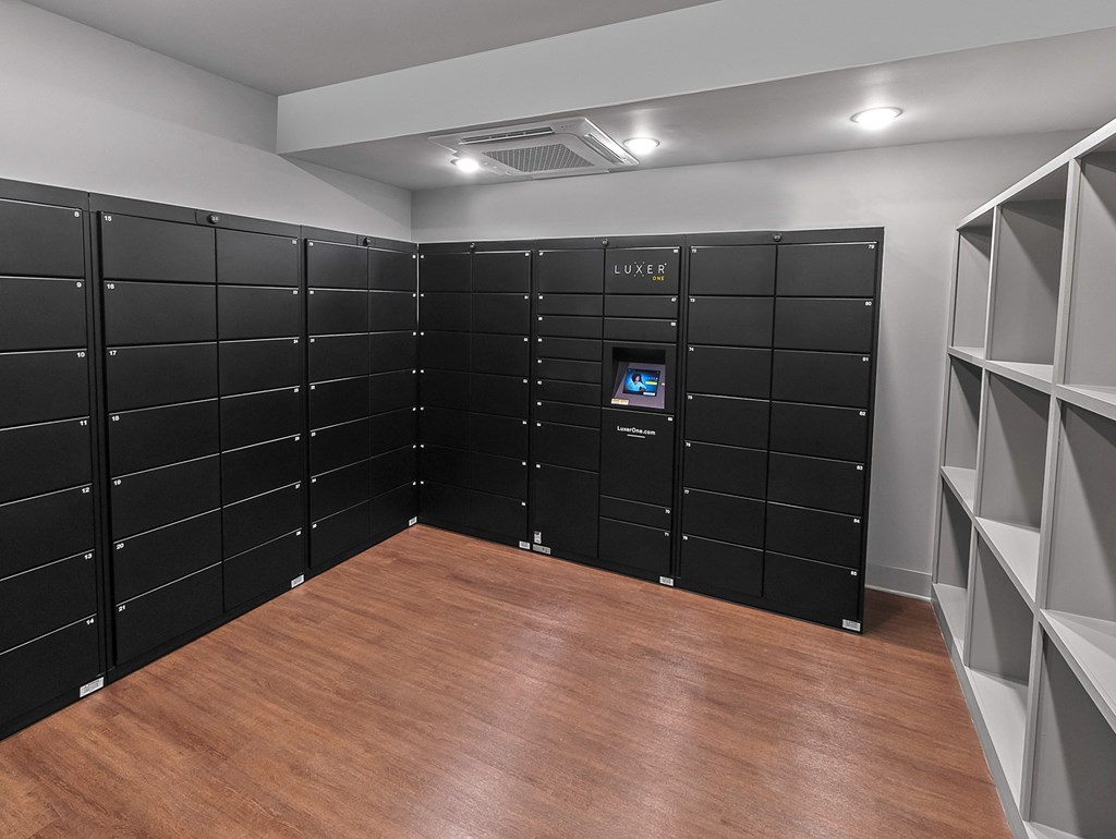 a room filled with black lockers with a wooden floor