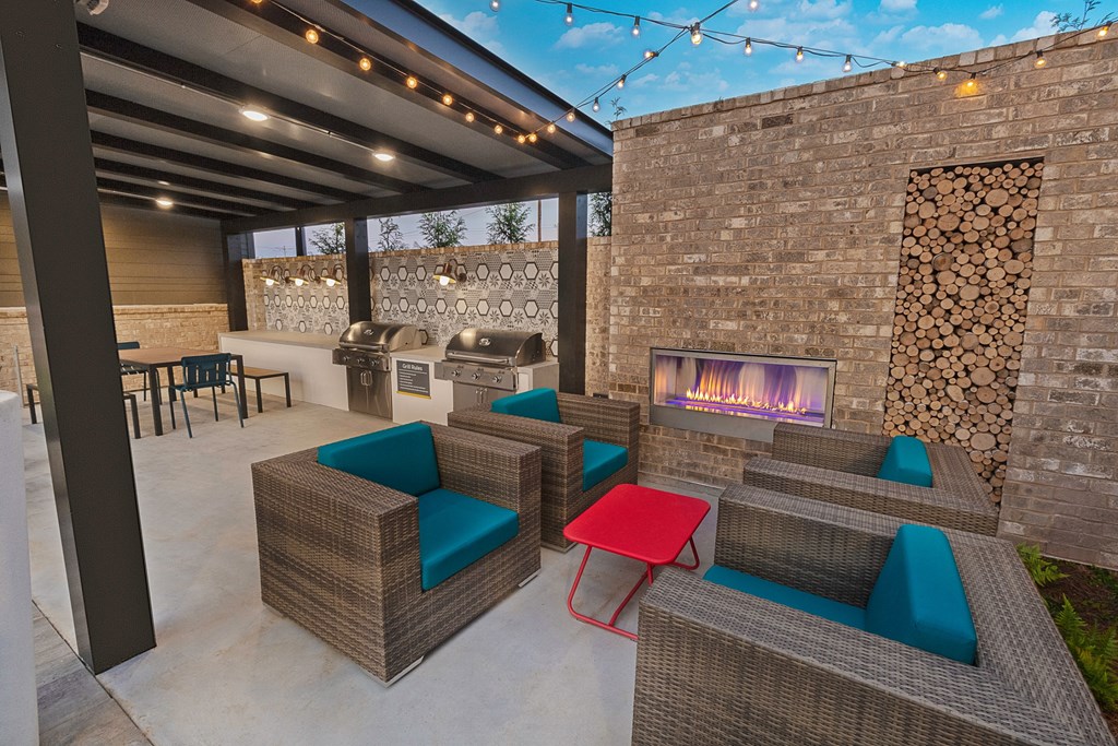 a patio with furniture and a fireplace