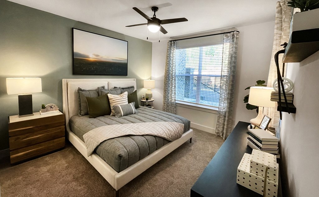 an empty bedroom with a bed and a ceiling fan