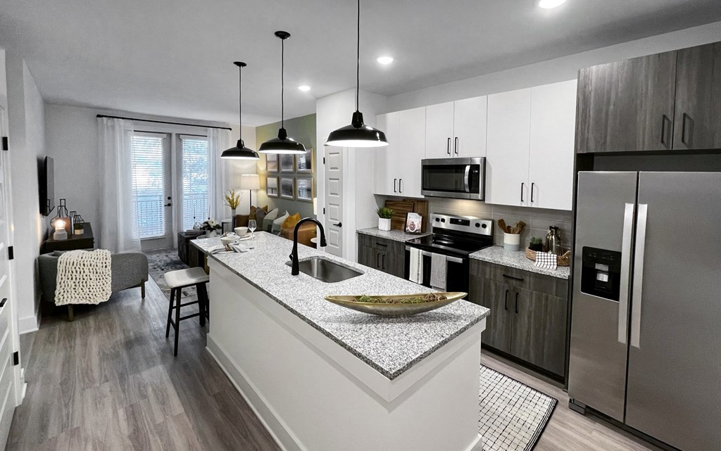 a kitchen with a large island and stainless steel appliances