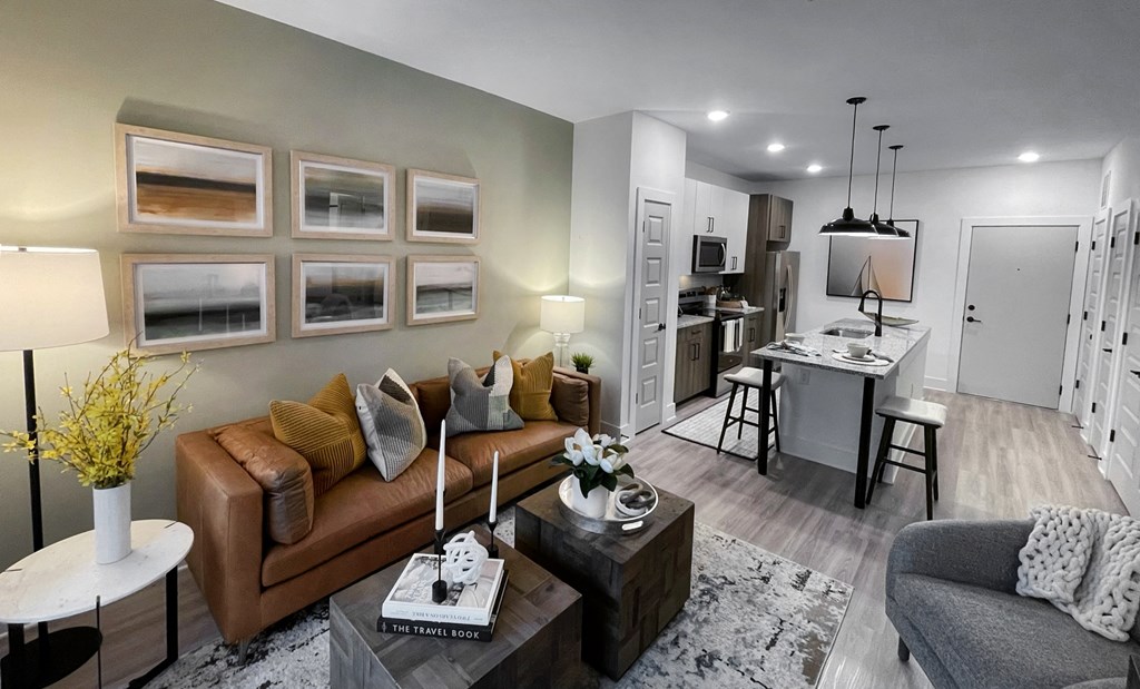 a living room and kitchen with a couch and a table