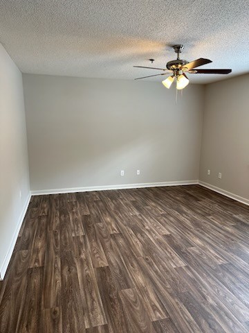 A room with a ceiling fan and wooden flooring.