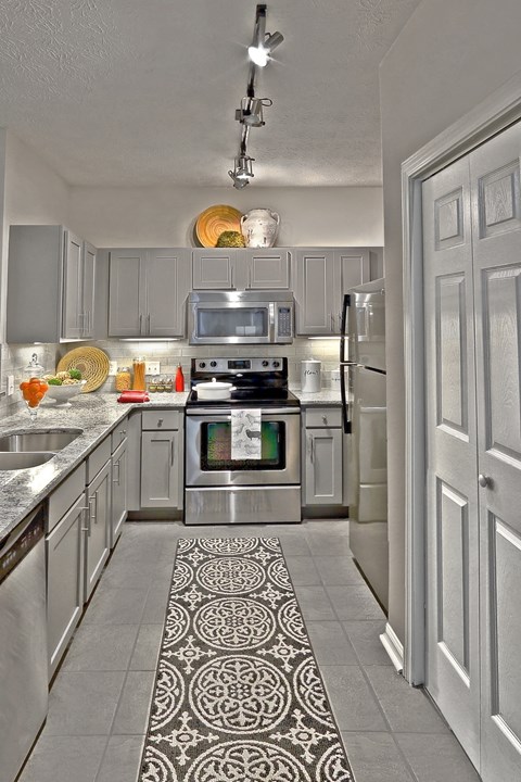a kitchen with stainless steel appliances and white cabinets