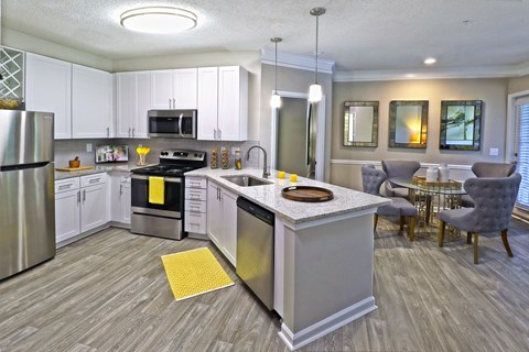 a kitchen with white cabinets and a counter top