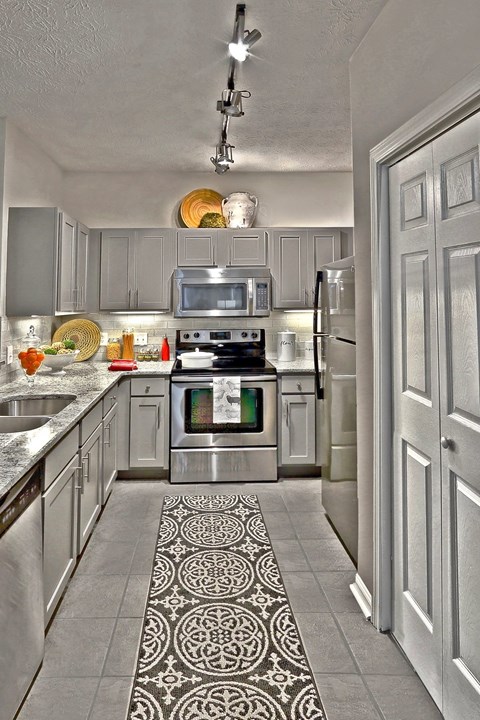 A modern kitchen with a patterned tile floor.