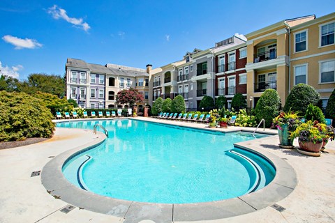 A swimming pool in front of apartment buildings.