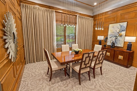 A dining room with a wooden table and chairs.