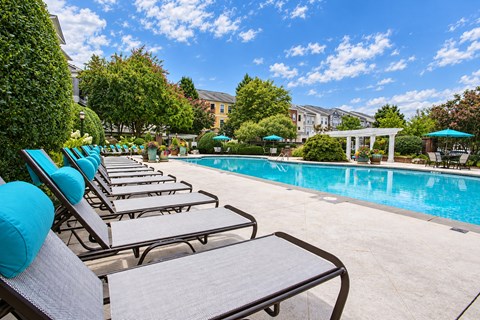 A pool with chairs around it.