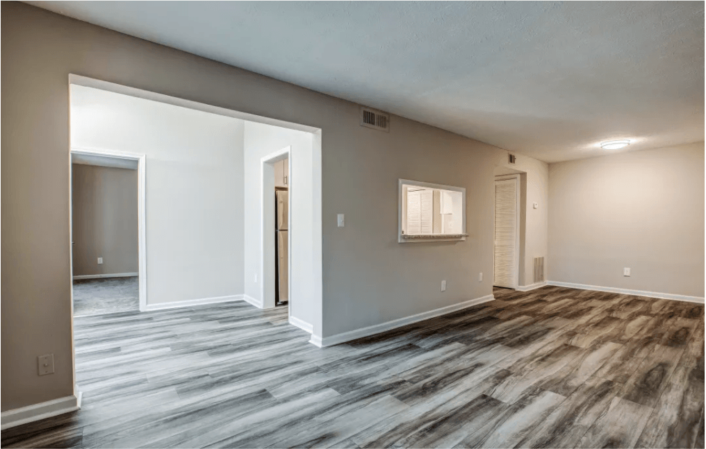 an empty living room with a door to a bedroom at Seven Pines, Alpharetta, GA