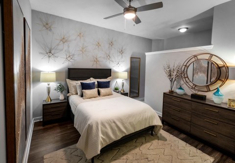 a bedroom with a bed and a ceiling fan