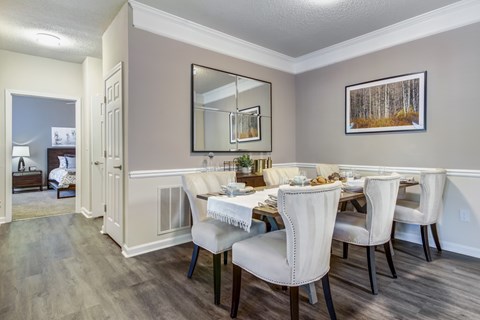 A dining room with a table set for four.
