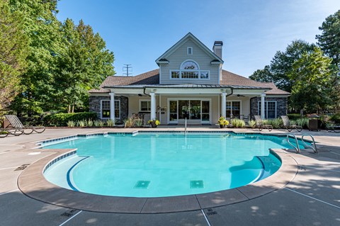 A house with a pool in front of it.