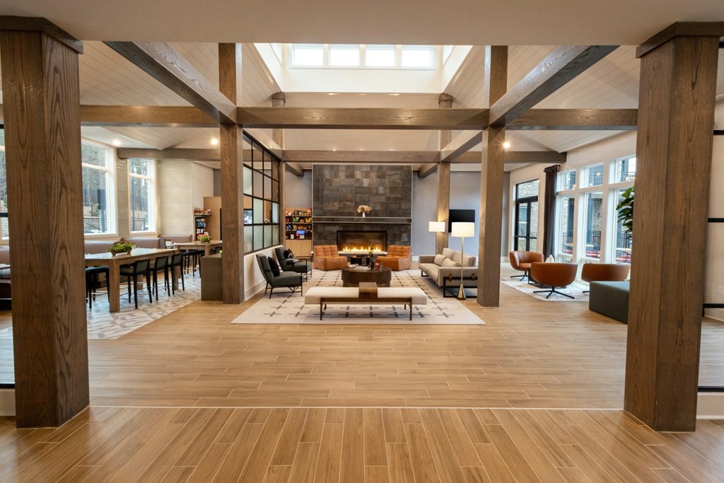 a large living room with a fireplace and wooden floors