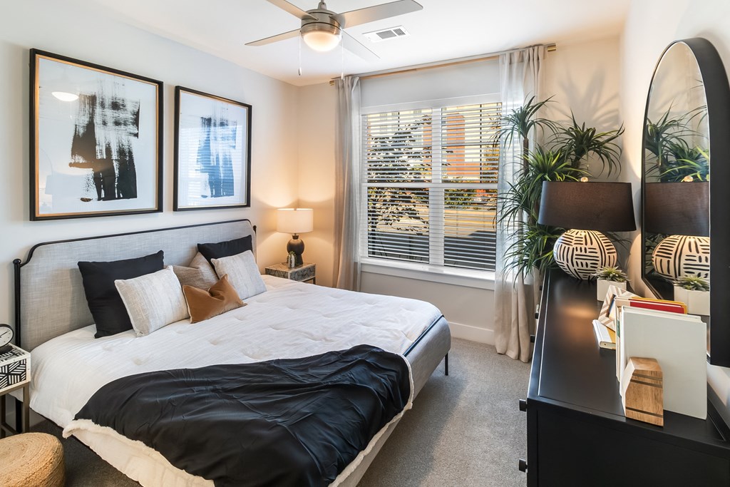 a bedroom with a large bed and a large window