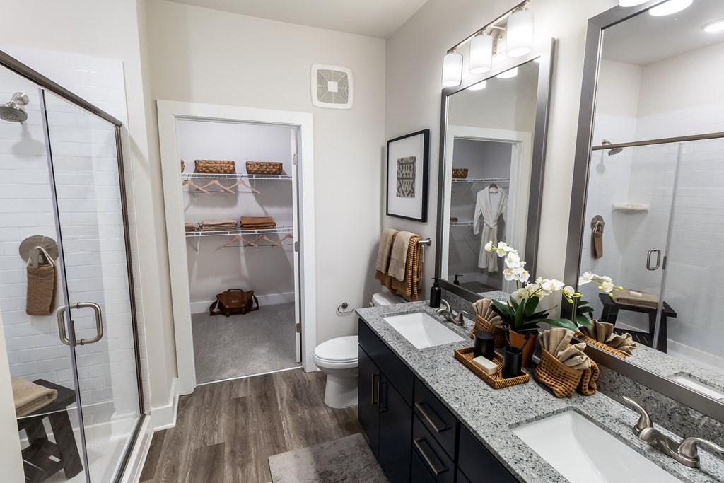 a bathroom with a shower and a sink and a mirror