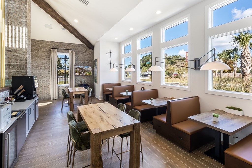 a dining room with tables and chairs and large windows