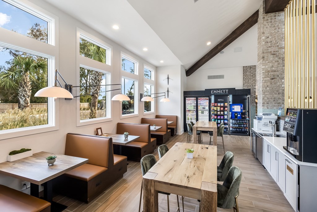 the dining area of a restaurant with tables and chairs and large windows