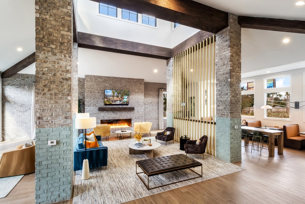 a living room with a fireplace and a table and chairs