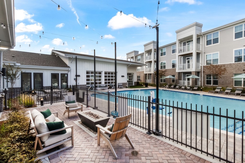 the preserve at ballantyne commons swimming pool with furniture and apartment buildings