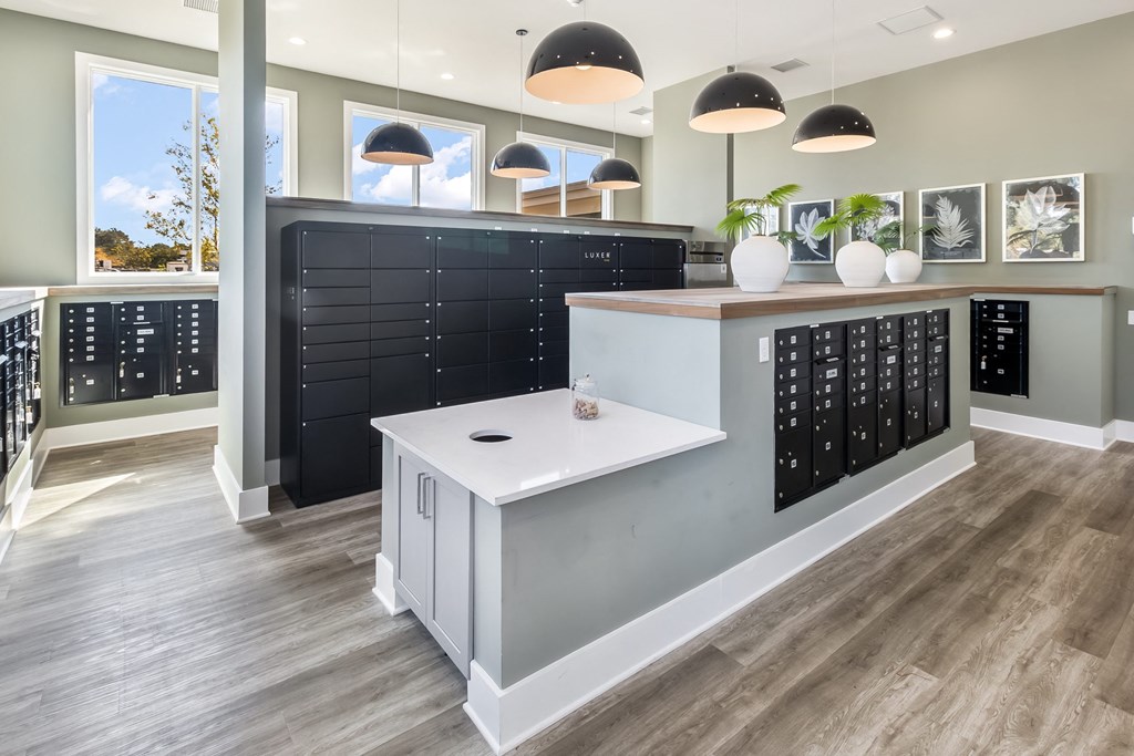 a view of the front of a store with a white counter top and black cabinets