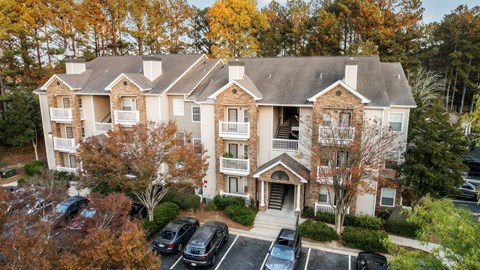A large apartment building with a parking lot in front. at North Park Estates, Alpharetta